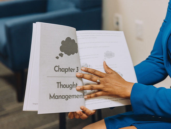 therapist holding a book during a presentation in outpatient therapy for teens