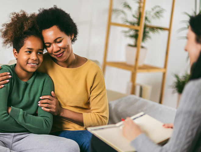 Mother hugging her teenage daughter during a therapy session at an adolescent mental health program in Jacksonville