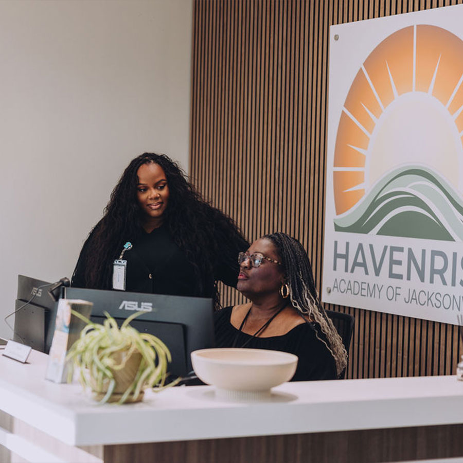 Receptionist at HavenRise Academy greeting clients as they enter of teen therapy and counseling center in San Marco