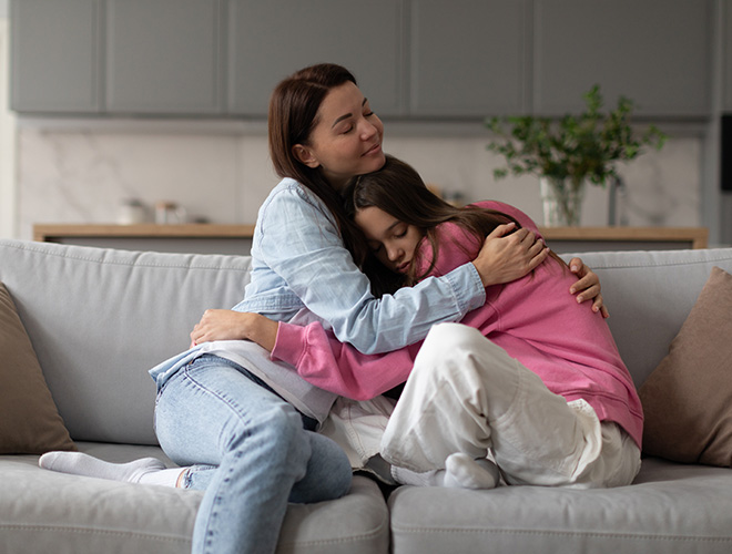 Mother comforting her teen daughter who struggles with an eating disorder