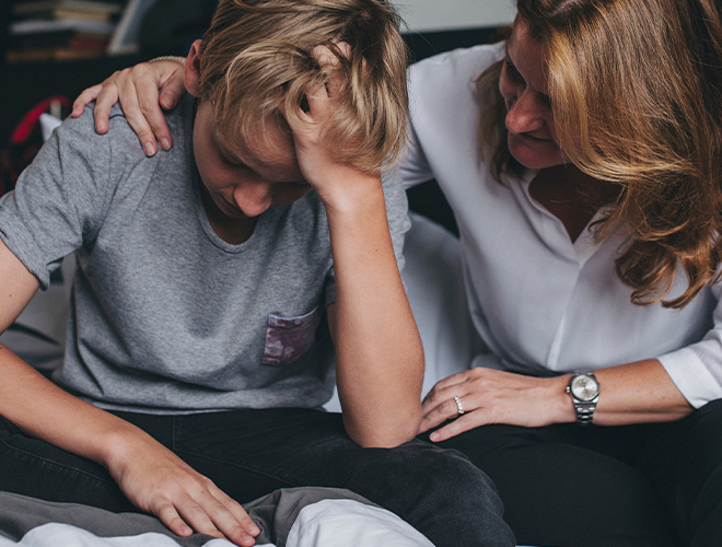 Mother comforts her son after an episode with teen anger management